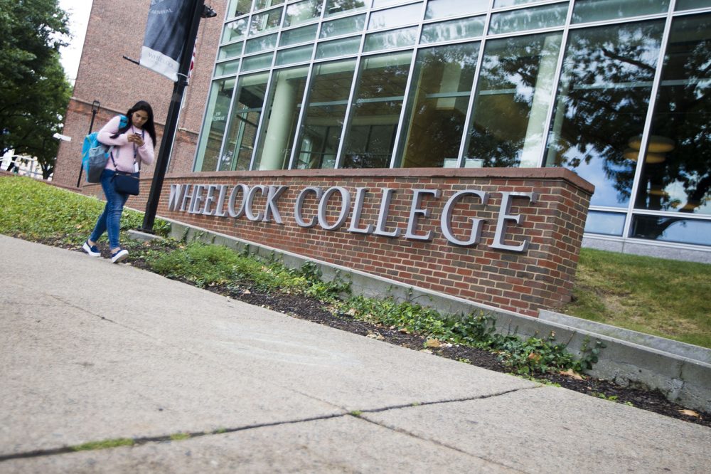 A student walks down the Riverway in front of the Wheelock College campus. (Jesse Costa/WBUR)