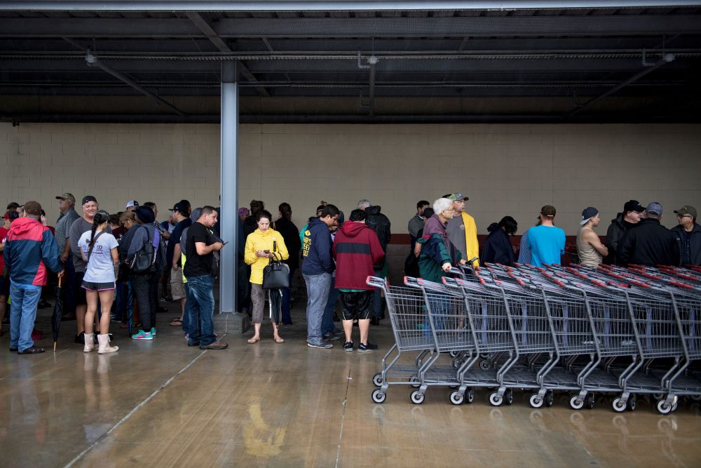 People wait in line for an H-E-B grocery store to open during the aftermath of Hurricane Harvey on Aug. 29, 2017 in Deer Park, Texas. (Brendan Smialowski/AFP/Getty Images)