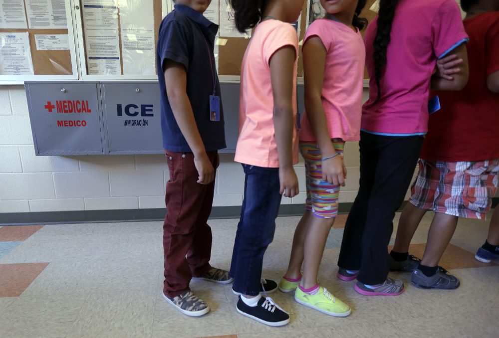 In this Sept. 10, 2014 file photo, detained immigrant children line up in the cafeteria at the Karnes County Residential Center, a temporary home for immigrant women and children detained at the border in Karnes City, Texas. (Eric Gay/AP)
