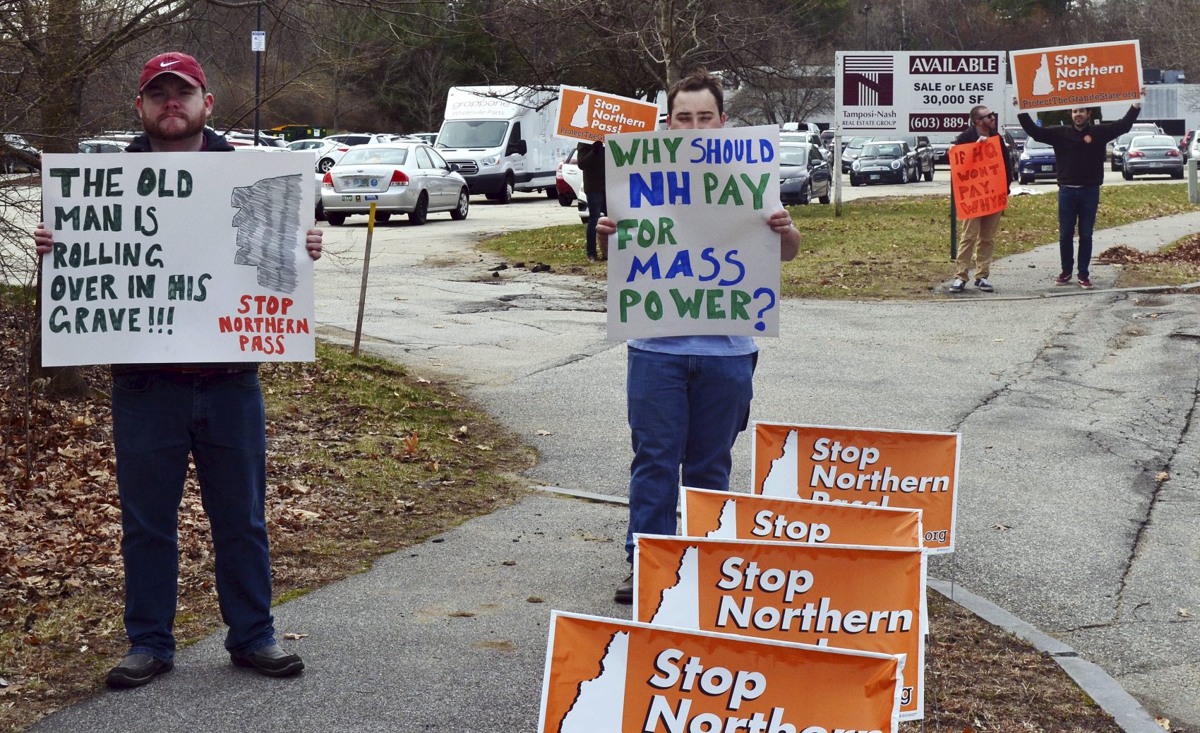 Opponents of the Northern Pass project, which would carry electricity from Hydro-Quebec's massive dam system in Canada to Massachusetts, protest outside a state hearing in Concord, New Hampshire, in April. Utilities bidding to supply clean energy to to hundreds of thousands of Massachusetts homes face a challenge: convincing residents of northern New England that it's in their interest to host the Bay State's extension cord. (Michael Casey/AP)