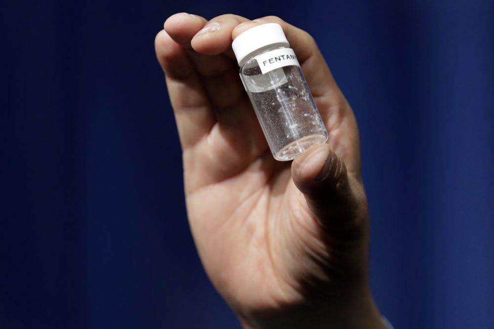 A reporter holds up an example of the amount of fentanyl that can be deadly after a news conference about deaths from fentanyl exposure, at DEA Headquarters in Arlington Va., Tuesday, June 6, 2017. (Jacquelyn Martin/AP)