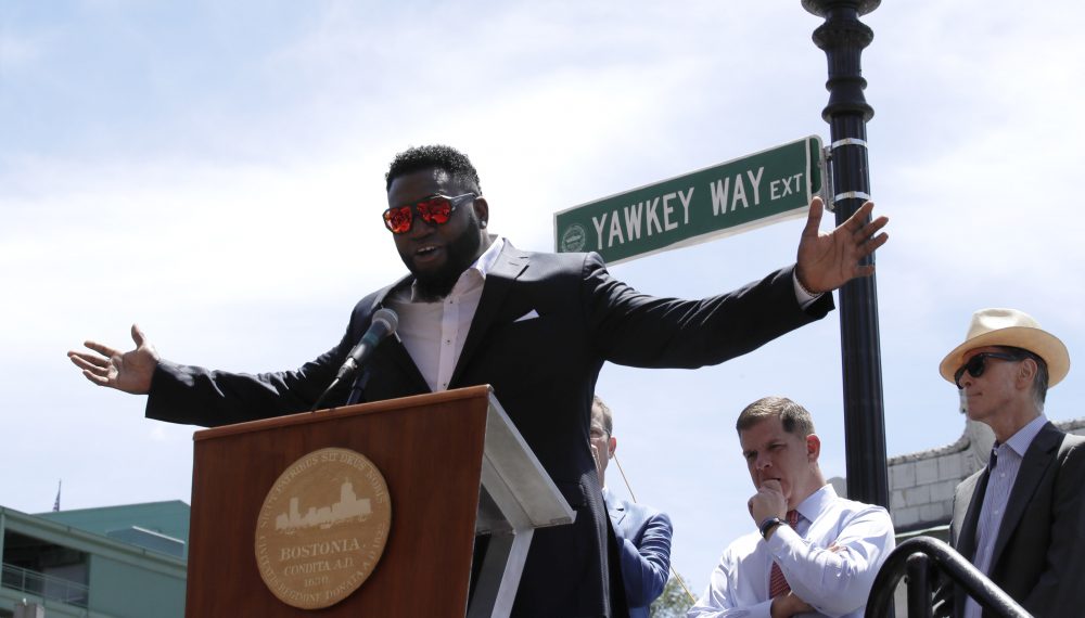 In this June 22, 2017 file photo, retired Boston Red Sox designated hitter David Ortiz is honored with the renaming of a portion of Yawkey Way to David Ortiz Drive outside Fenway Park in Boston. Red Sox principal owner John Henry, at right, says he wants to take steps to rename all of Yawkey Way, a street that has been an enduring reminder of the franchise's complicated racial past. At center rear is Boston Mayor Marty Walsh. (Charles Krupa/AP)