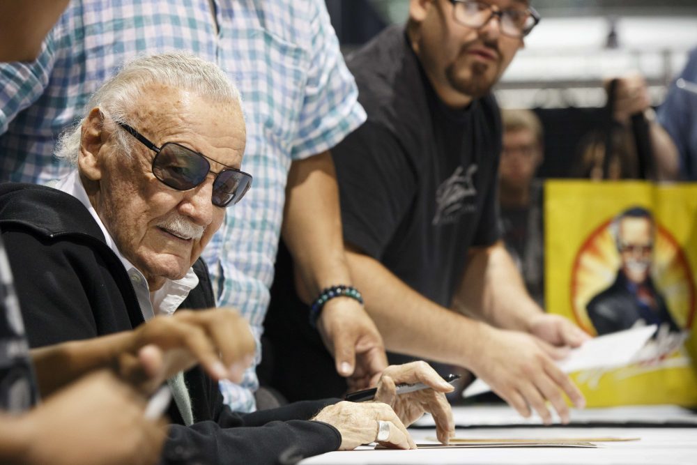 Stan Lee signs autographs at Boston Comic Con on Friday. (Michael Dwyer/AP)