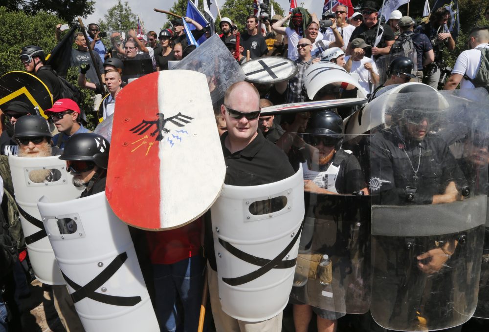 White nationalist demonstrators use shields as they guard the entrance to Lee Park in Charlottesville on Saturday. (Steve Helber/AP)