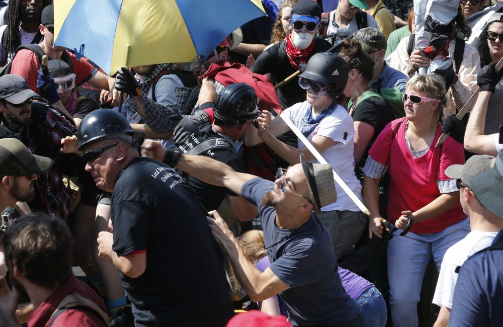 White nationalist demonstrators clash with counter demonstrators at the entrance to Lee Park in Charlottesville, Va., Saturday, Aug. 12, 2017. Gov. Terry McAuliffe declared a state of emergency and police dressed in riot gear ordered people to disperse after chaotic violent clashes between white nationalists and counter protestors. (Steve Helber/AP)