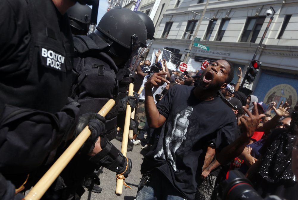 Police move toward a counter-protester. (Michael Dwyer/AP)