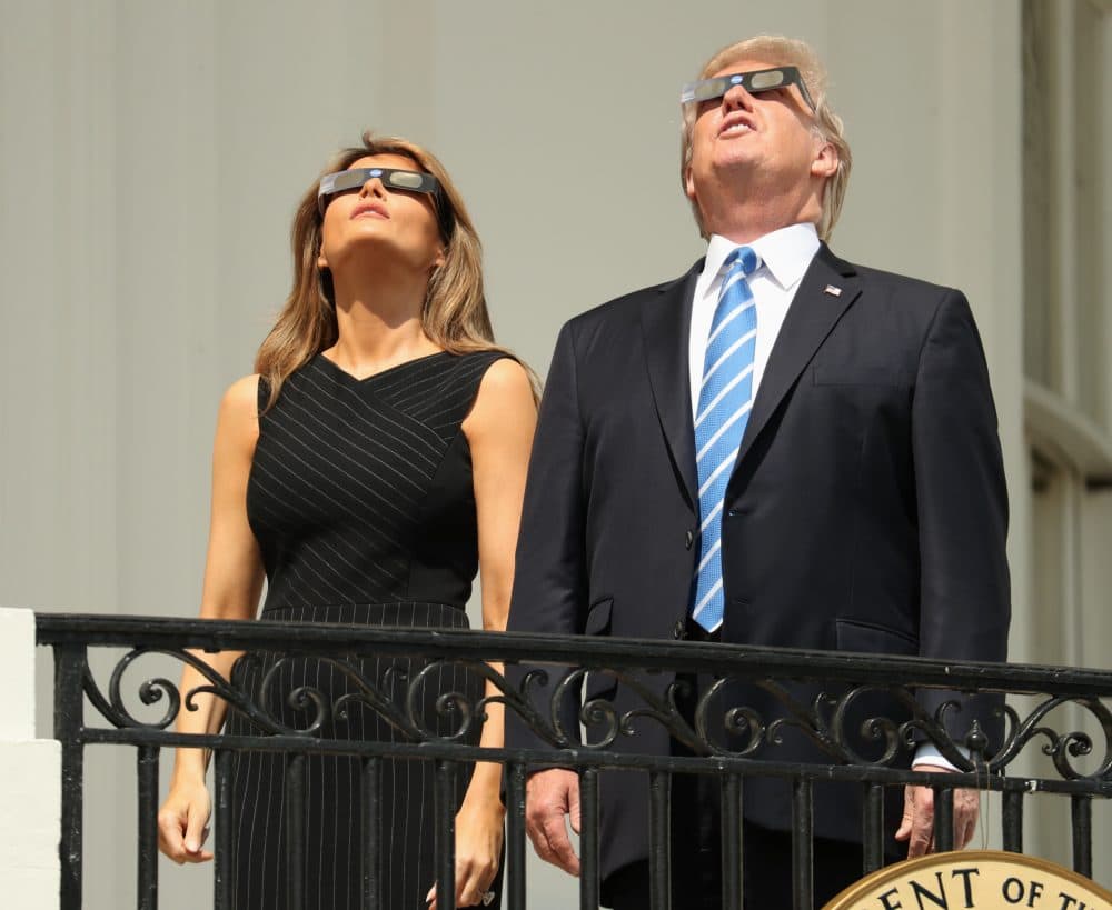 President Donald Trump and First Lady Melania Trump wear protective glasses as they view the solar eclipse Monday at the White House. (Andrew Harnik/AP)