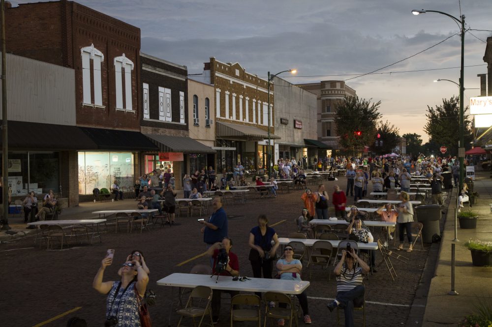 People watch the height of the solar eclipse as sunlight fades away in downtown Falls City, Nebraska. (Nati Harnik/AP)