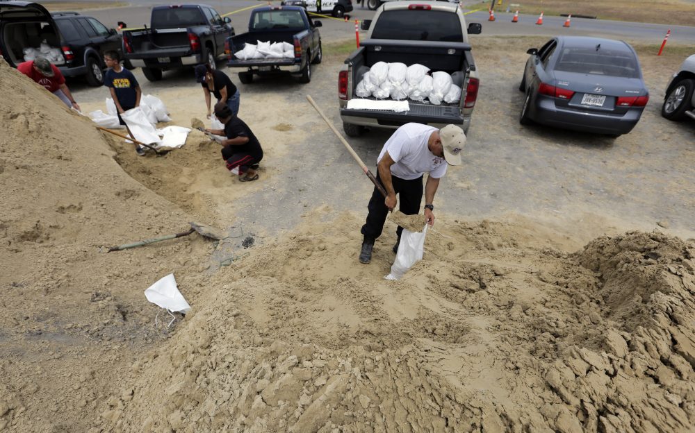 Martin Quintanilla fills sandbags as he and other residents prepare for Hurricane Harvey Thursday in Corpus Christi, Texas. (Eric Gay/AP)