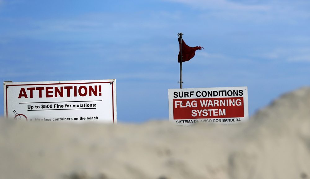 A red warning flag flaps in the wind Thursday in Port Aransas, Texas. (Eric Gay/AP)