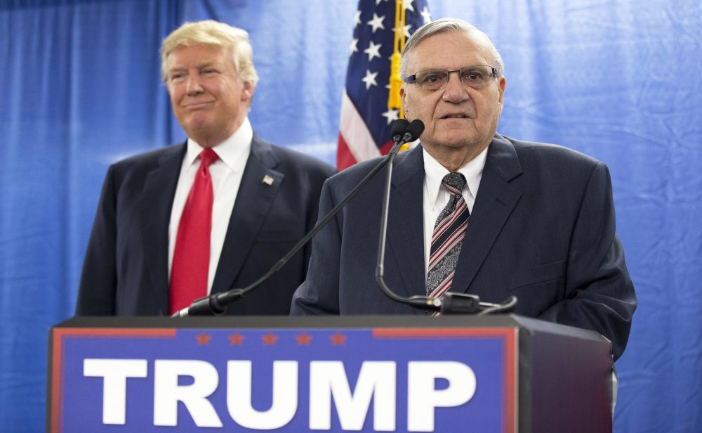 In this 2016 file photo, then-Republican presidential candidate Donald Trump is joined by then-Maricopa County, Ariz., Sheriff Joe Arpaio during a new conference in Marshalltown, Iowa. Trump has pardoned Arpaio following his conviction for intentionally disobeying a judge's order in an immigration case. The White House announced the move Friday night, saying the 85-year-old ex-sheriff was a &quot;worthy candidate&quot; for a pardon. (Mary Altaffer/AP)