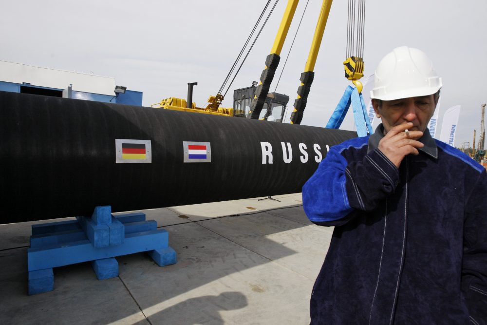 In this Friday, April 9, 2010 file photo a Russian construction worker smokes in Portovaya Bay, Russia, during a ceremony marking the start of Nord Stream pipeline construction. (Dmitry Lovetsky/ AP)