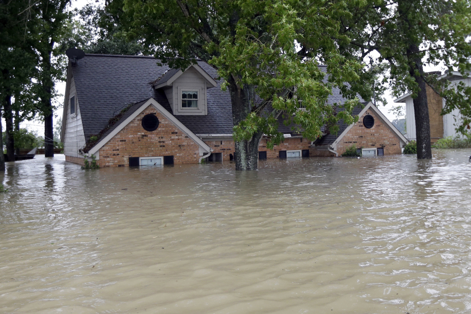 A home is surrounded by floodwaters from Tropical Storm Harvey in Spring, Texas. (David J. Phillip/AP)