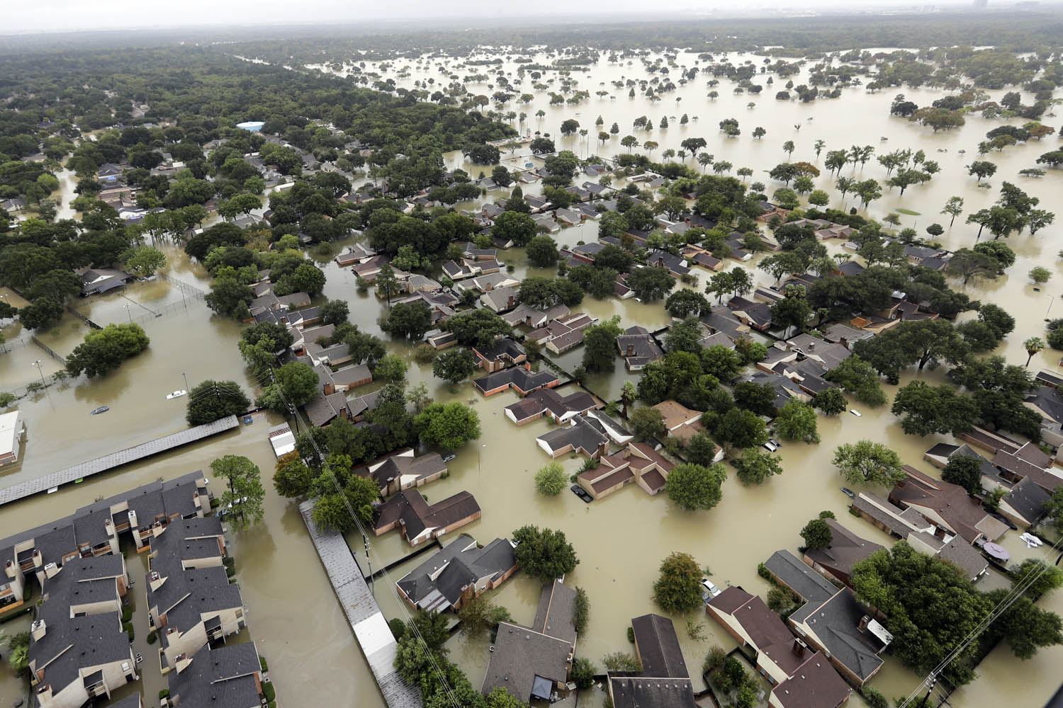 Water from Addicks Reservoir flows into neighborhoods as floodwaters from Tropical Storm Harvey rise Tuesday, Aug. 29 in Houston. (David J. Phillip/AP)