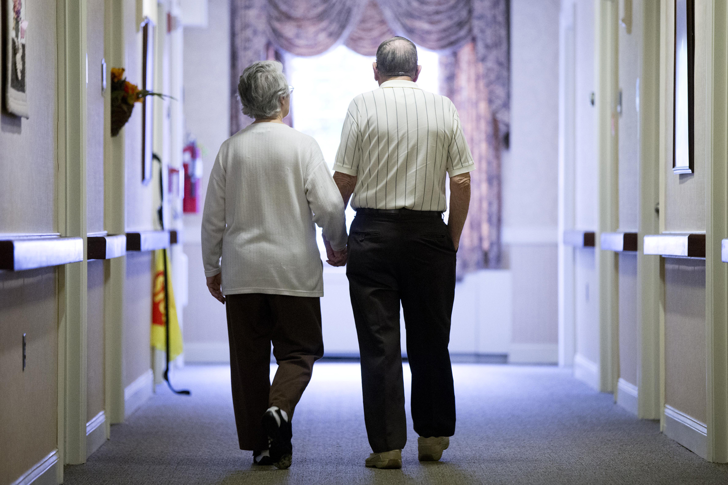 Decima Assise and Harry Lomping walk the halls, Friday, Nov. 6, 2015, at The Easton Home in Easton, Pa. (Matt Rourke/AP)