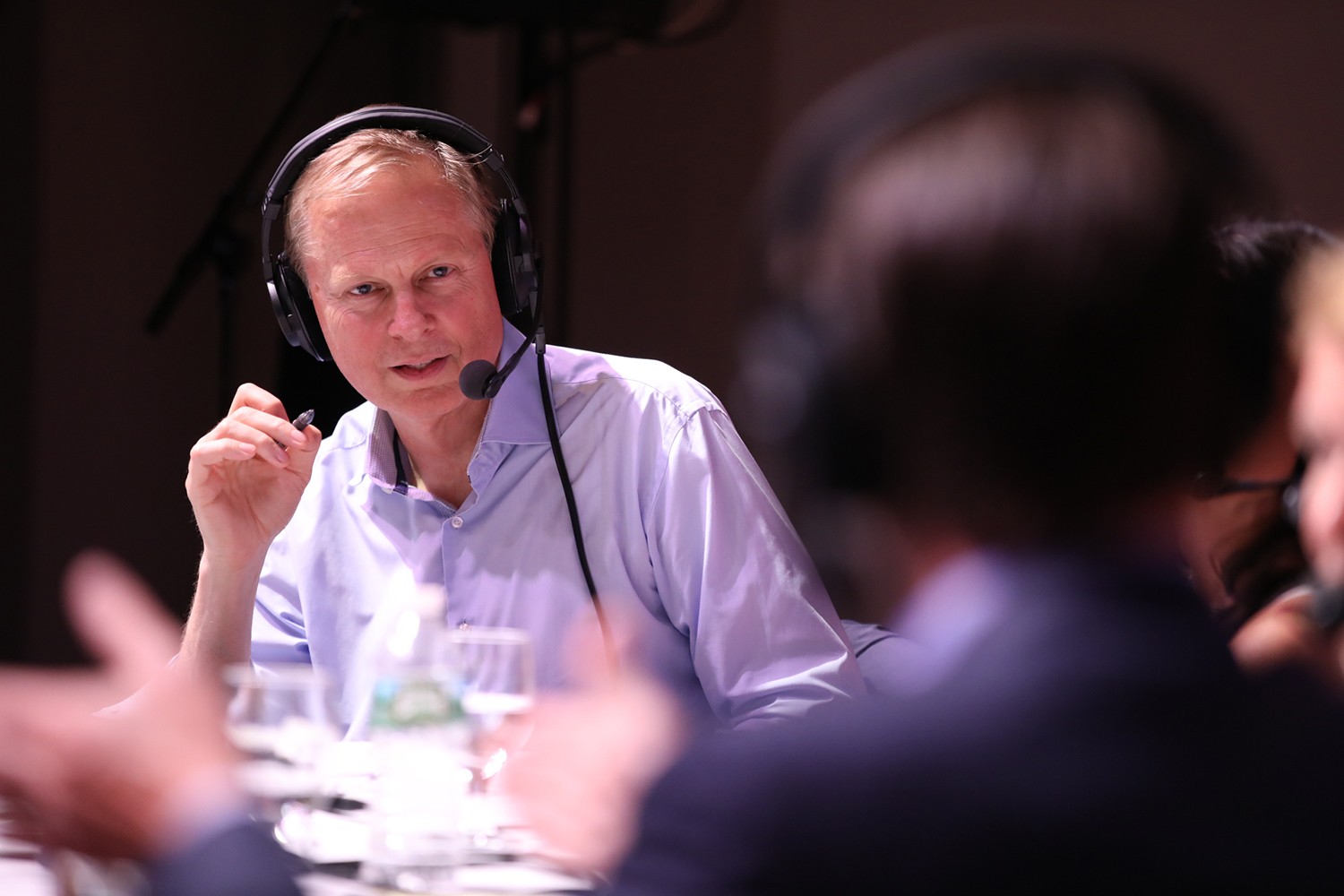 Tom Ashbrook moderates a discussion at the #OnPointLive show in Portland, Maine. (Brian Bechard/Maine Public)