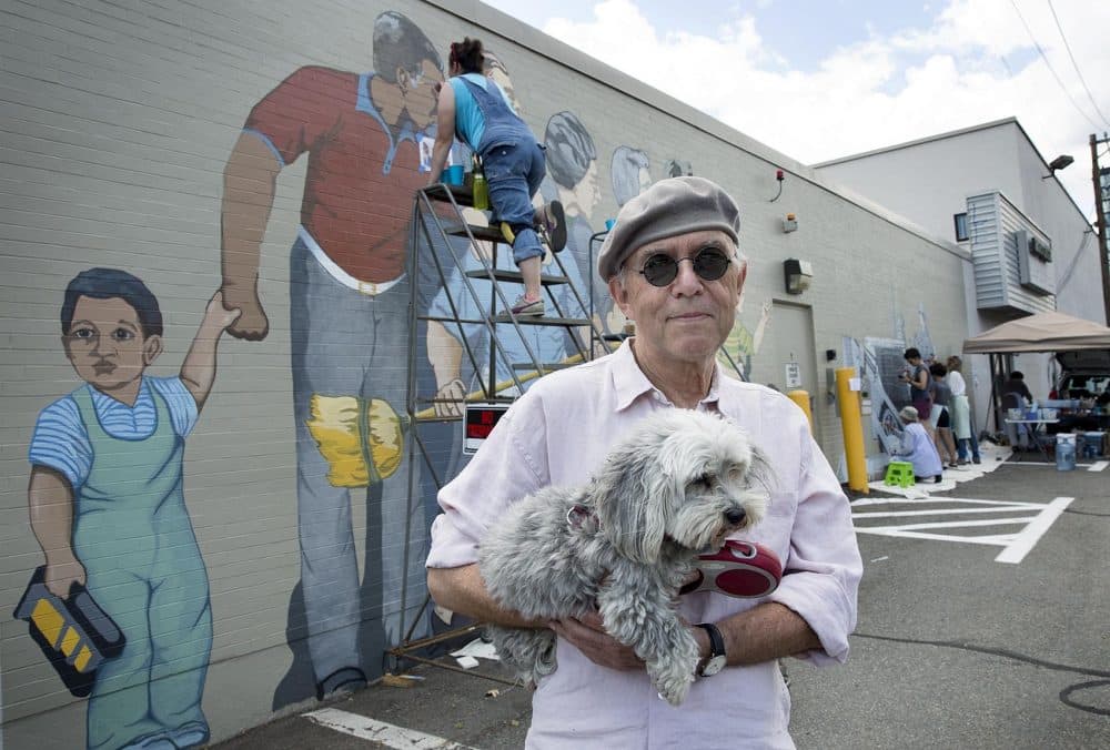 Artist Bernie LaCasse, 74, with his dog Misty Moonlight in front of his &quot;Beat the Belt&quot; mural in Cambridgeport. (Robin Lubbock/WBUR)