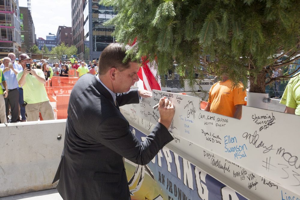 Mayor Martin Walsh signing the final steel beam at the topping-off ceremony for One Seaport Square in July, 2016. (Joe Difazio for WBUR)