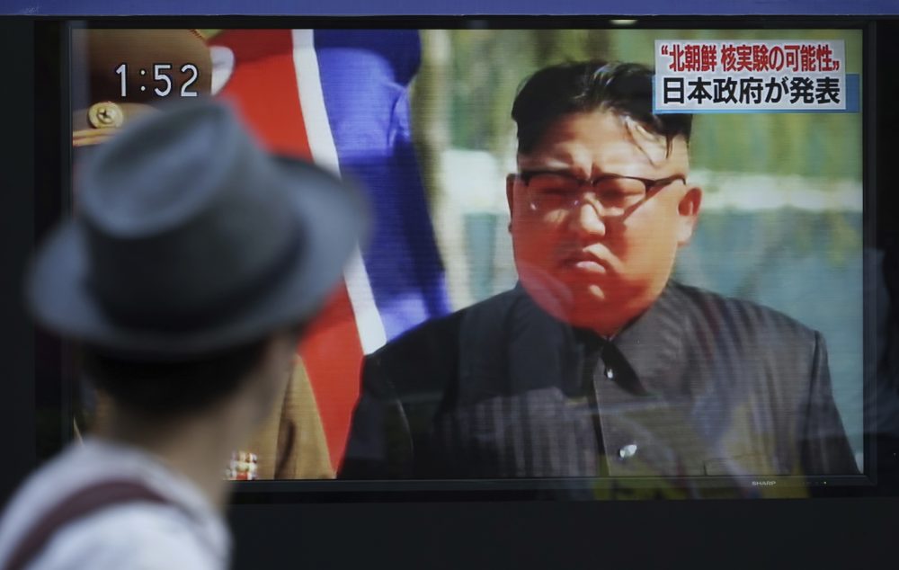 A man watches a TV news program on a public screen showing an image of North Korean leader Kim Jong Un while reporting North Korea's possible nuclear test in Tokyo Sunday, Sept. 3, 2017. (Eugene Hoshiko/AP)