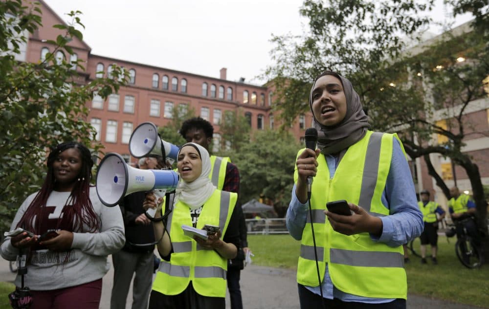 Harvard University students Anwar Omeish, of Fairfax, Va., center, and Salma Abdelrahman, of Miami, right, chant slogans as they protest a scheduled speaking appearance of author Charles Murray at Harvard on Wednesday. (Steven Senne/AP)