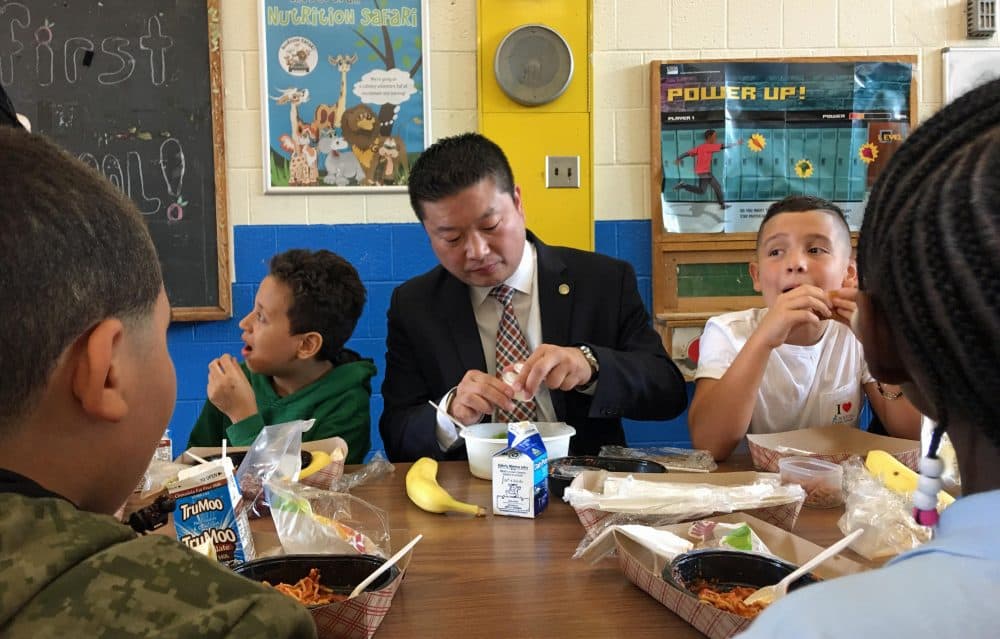 Tommy Chang tries the new lunches at Blackstone School in the South End on the first day of school Thursday. (Max Larkin/WBUR)