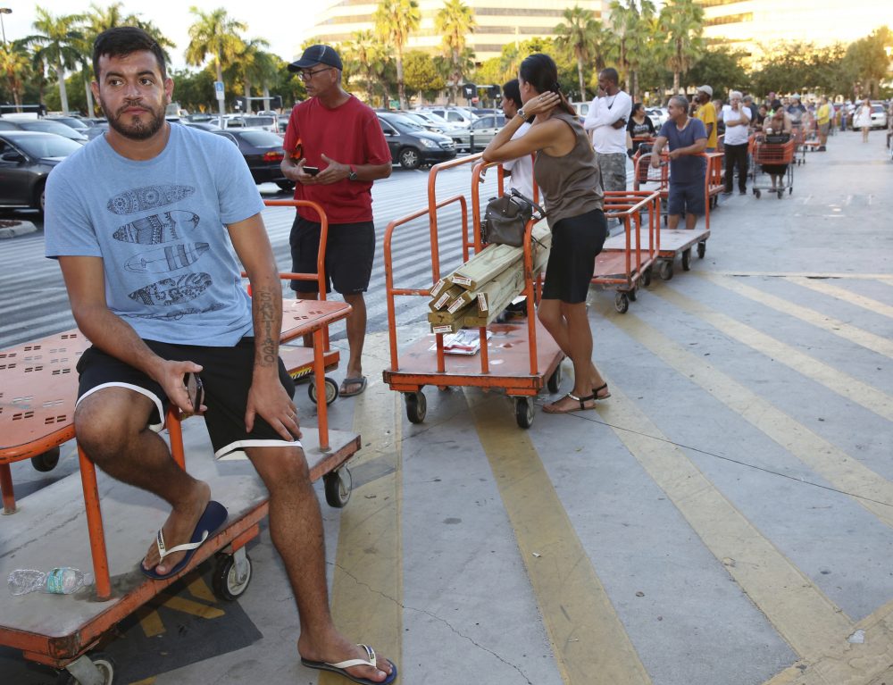 Max Garcia, of Miami, waits in a line since dawn to purchase plywood sheets at The Home Depot store in North Miami, Fla. (Marta Lavandier/AP)