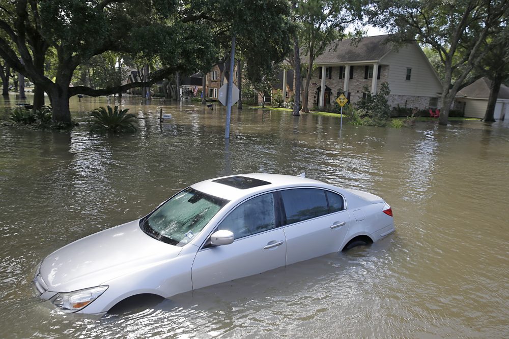 A car floats in a street flooded with water in Lakeside Estate in Houston on Aug. 30, 2017. (Thomas B. Shea/AFP/Getty Images)
