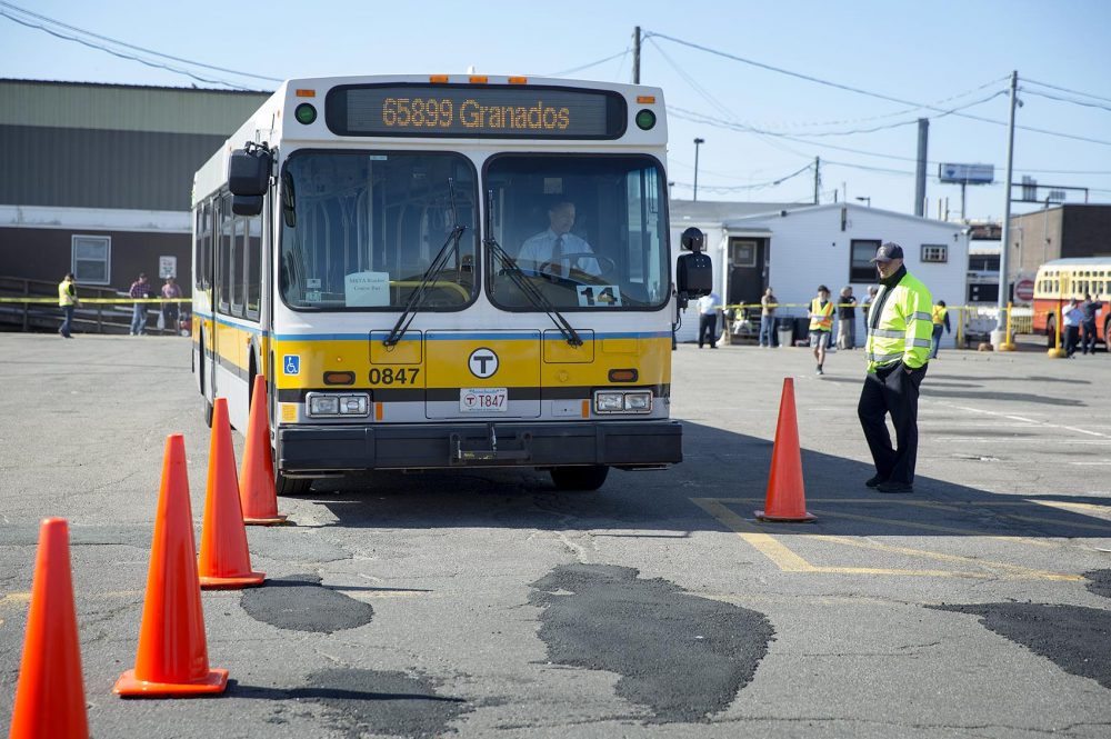 A contestant guides his bus between cones at the MBTA Roadeo in Charlestown. (Robin Lubbock/WBUR)