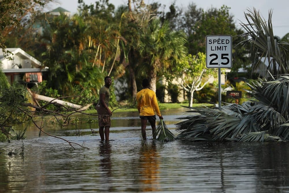 People walk through flooded streets the morning after Hurricane Irma swept through the area on Sept. 11, 2017 in Fort Myers, Fla. (Spencer Platt/Getty Images)