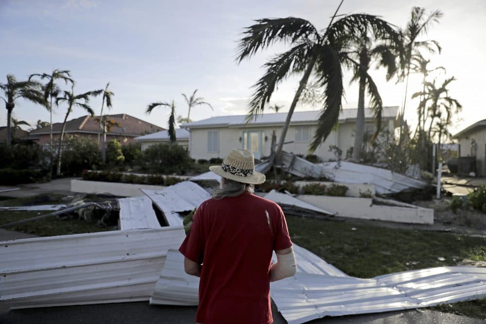 A roof is strewn across a home's lawn as Rick Freedman checks his neighbor's damage from Hurricane Irma in Marco Island, Fla., Monday, Sept. 11, 2017. (David Goldman/AP)
