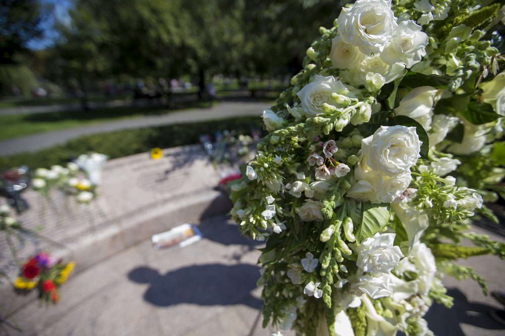 A wreath of flowers stands in front of the 9/11 Memorial in Boston's Public Garden. (Jesse Costa/WBUR)