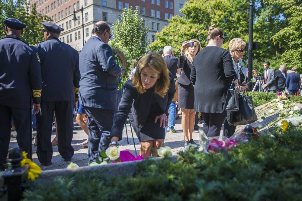 Lt. Gov. Karyn Polito lays a white rose on the 9/11 Memorial after the conclusion of the wreath laying ceremony. (Jesse Costa/WBUR)