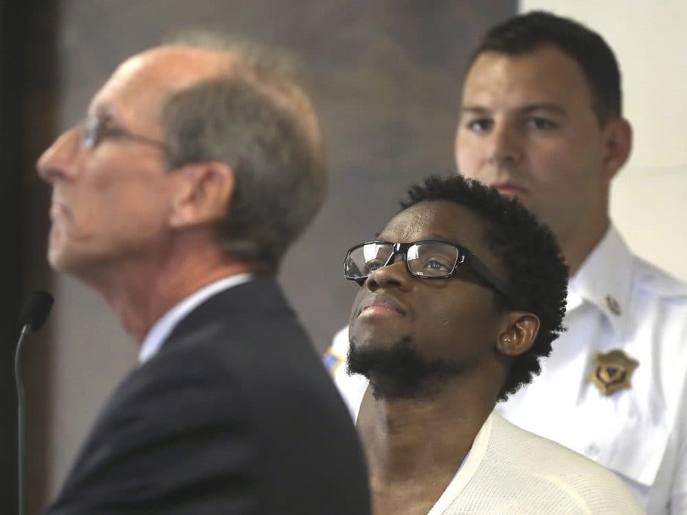 In this July 10 file photo, Bampumim Teixeira, center, is arraigned in Suffolk Superior Court in Boston before Clerk Magistrate Edward Curley. (Pat Greenhouse/The Boston Globe via AP, pool)
