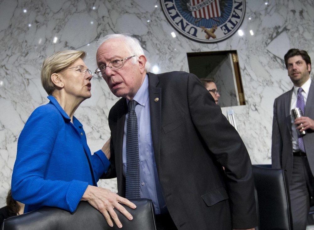 Sen. Elizabeth Warren speaks with Sen. Bernie Sanders at a Senate committee hearing in Washington last week. (Jose Luis Magana/AP)