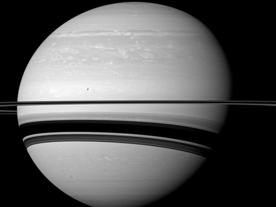 This Jan. 10, 2012 image made available by NASA shows Saturn and one of its moons, Tethys, as seen from the Cassini spacecraft. (NASA/JPL-Caltech/Space Science Institute via AP)
