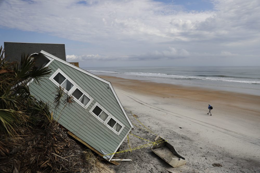A house rests on the beach after collapsing off a cliff from Hurricane Irma in Vilano Beach, Fla. on Sept. 15. Florida’s economy has long thrived on one major import: people. Irma raised concerns about just how sustainable the allure of Florida’s year-round warmth and lifestyle are. (David Goldman/AP)