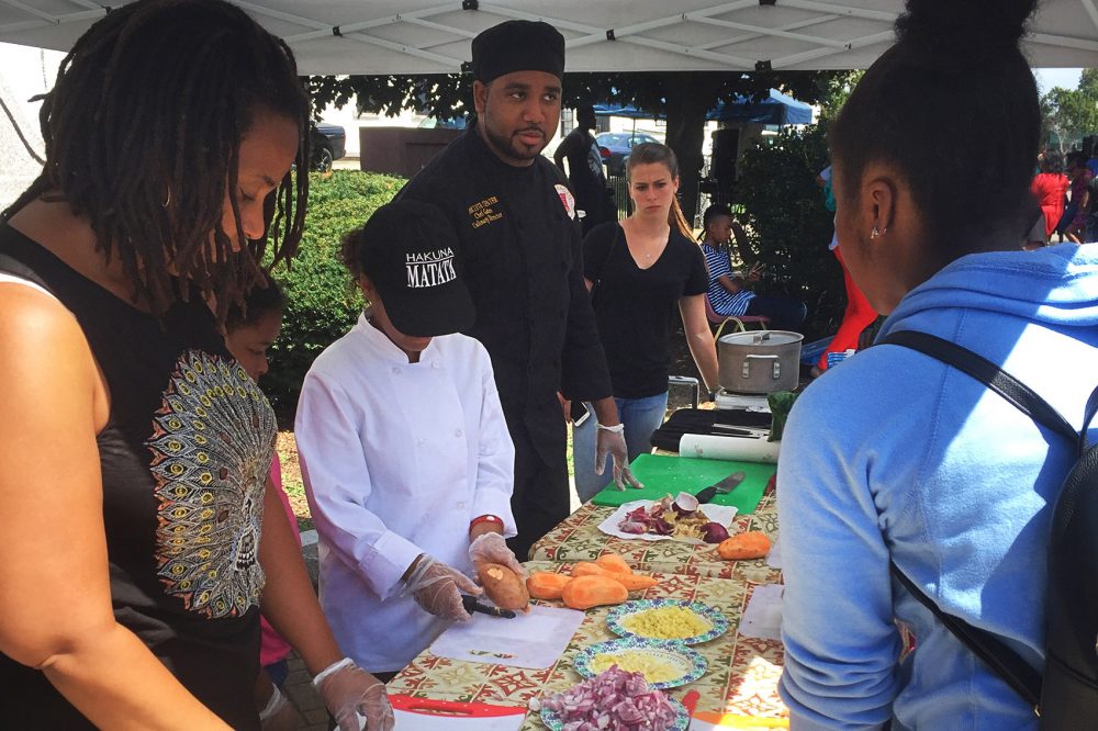 Gates Cleghorn conducts a cooking class in Codman Square. (Fred Thys/WBUR)