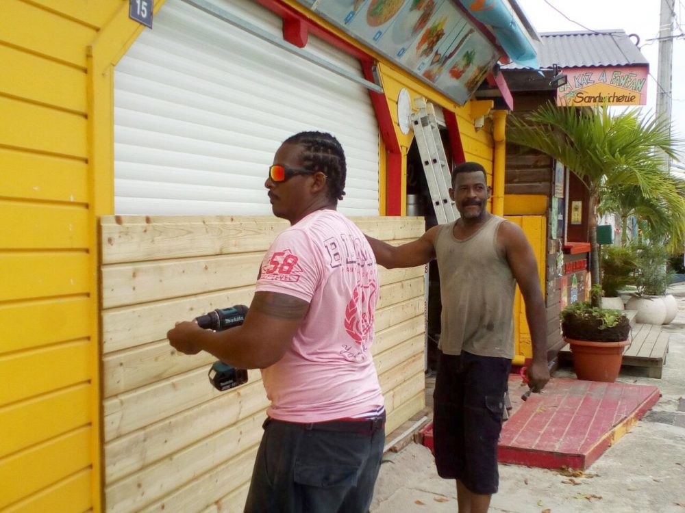 Men board up buildings ahead of Hurricane Maria in Sainte-Anne on the French Caribbean island of Guadeloupe on Monday. (Dominique Chomereau-Lamotte/AP)
