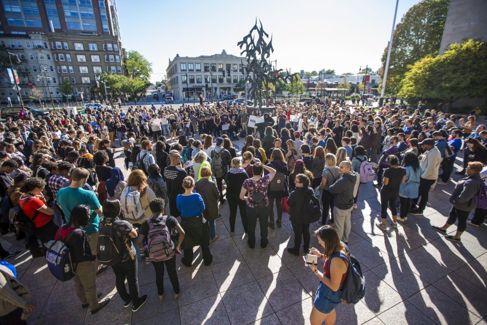 Black Lives Matter protesters gather in October 2016 in Boston University's Marsh Plaza. In the center is the sculpture, &quot;Free At Last,&quot; that honors MLK's legacy. (Jesse Costa/WBUR)