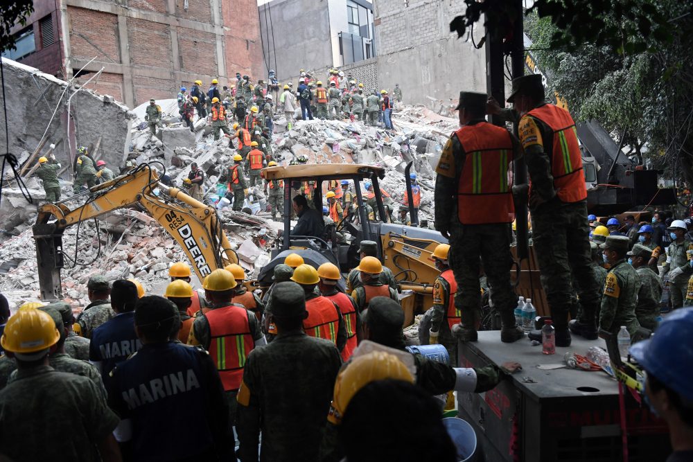 Volunteers remove rubble during the search for survivors in a flattened building in Mexico City on Sept. 20, 2017, after a strong quake hit central Mexico. (Pedro Pardo/AFP/Getty Images)