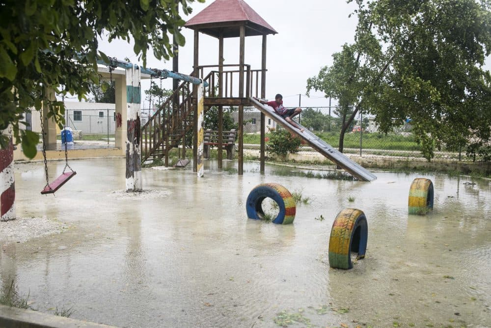 A boy plays at a flooded playground close to a shelter, while Hurricane Maria approaches the coast of Bavaro, Dominican Republic on Wednesday. (Tatiana Fernandez/AP)