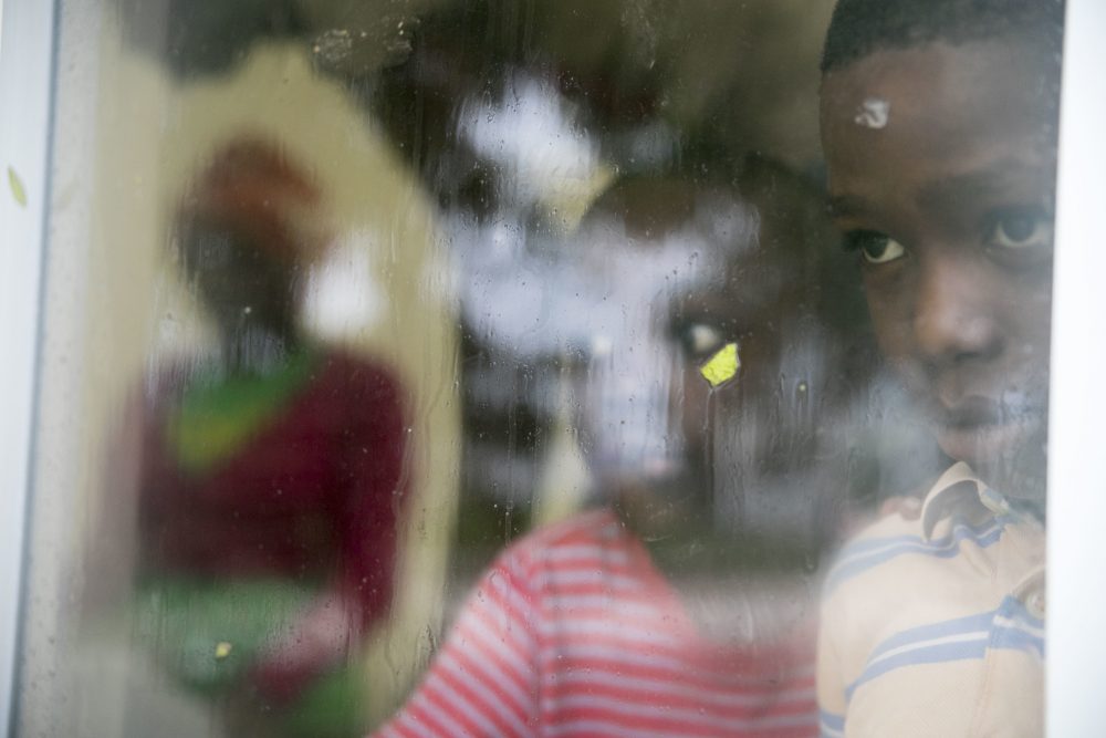 Boys look out the window of the Hoyo de Friusa Community Center, which is serving as a shelter while Hurricane Maria approaches the coast of Bavaro, Dominican Republic on Wednesday. (Tatiana Fernandez/AP)