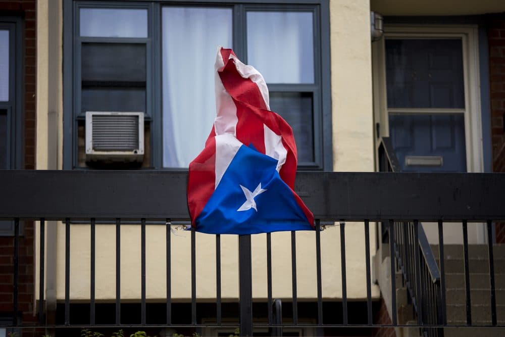 A Puerto Rican flag hung from the balcony of a West Dedham Street apartment building. (Jesse Costa/WBUR)