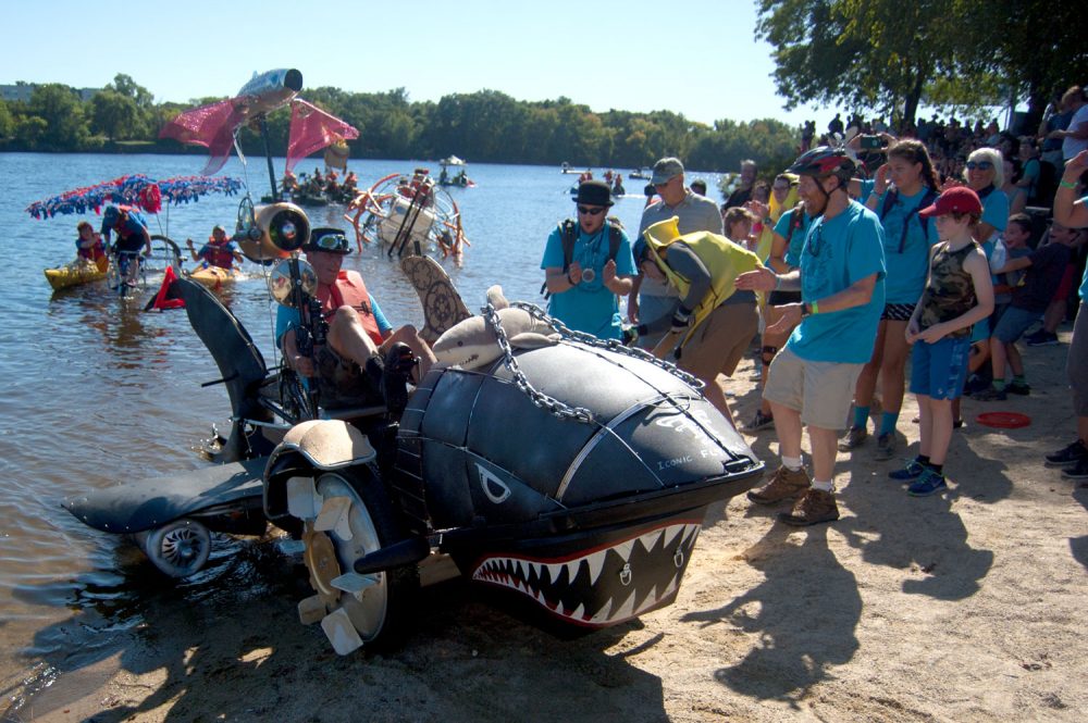 Jay Hungate’s shark-shaped “Iconic Flying Fish&quot; rolls out of the Merrimack River. (Greg Cook/WBUR)