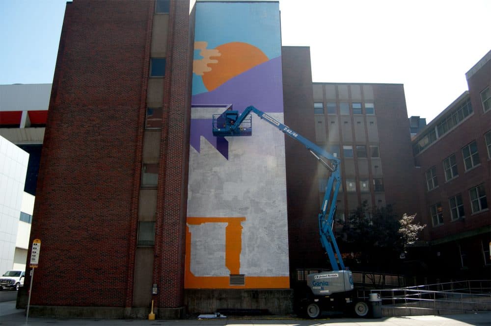 Tim McCool works on his sunrise mural at 774 Albany St., Boston, on Sept. 24, 2017. (Greg Cook)