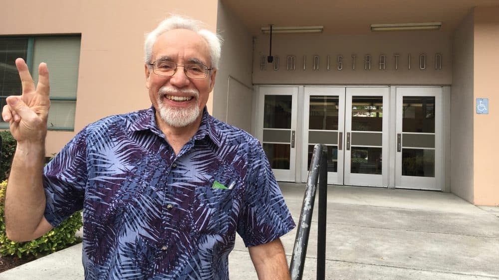Gil Villagran stands in front of the administration building at San Jose State University. He now teaches at the School of Social Work, but was expelled in the 1960s after participating in an anti-war protest. (Rachael Myrow/KQED)