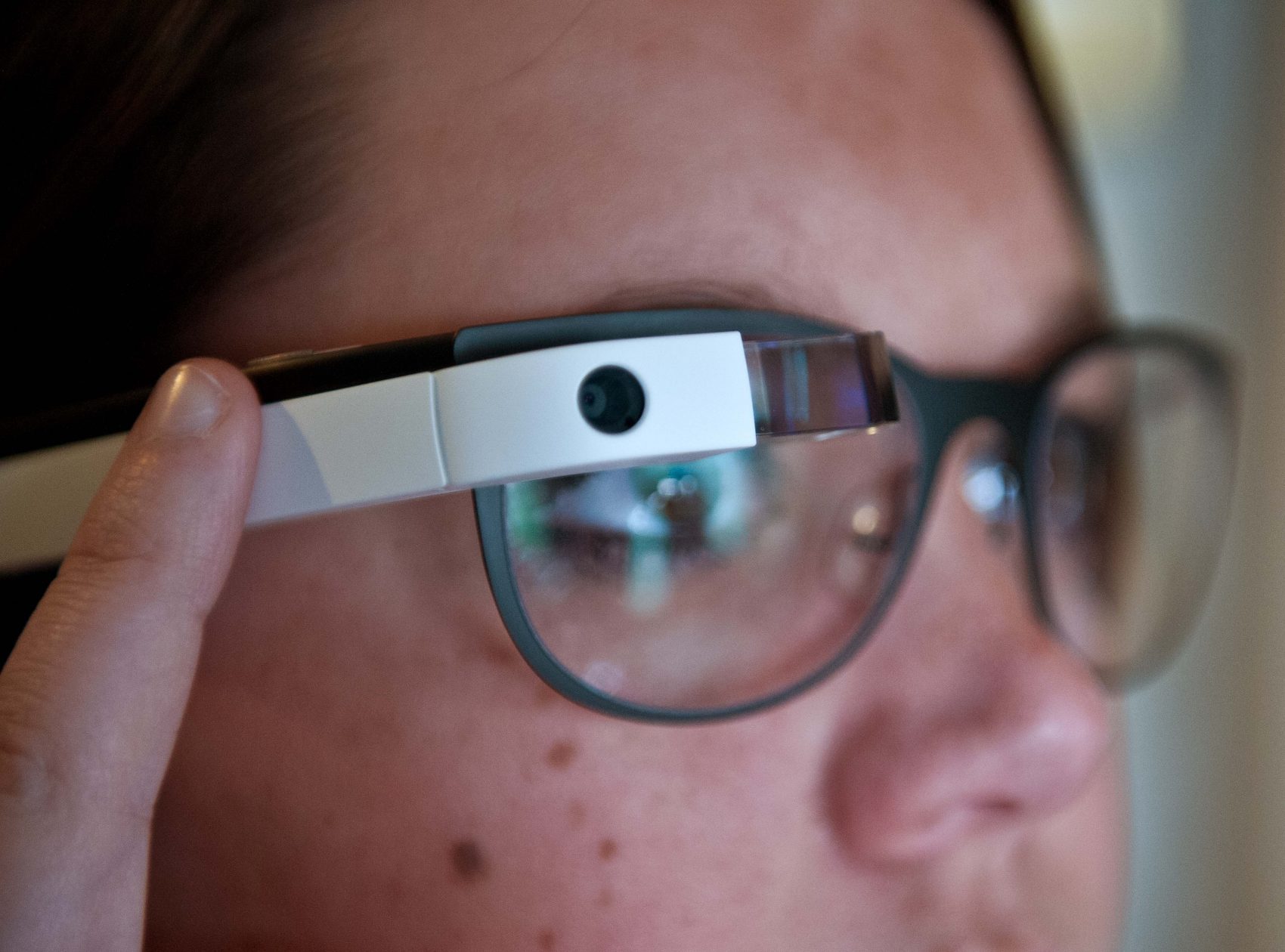 Allyson Cannon, recruitment manager of the National Press Club, uses her finger to scroll through pictures as she tries Google Glass at the National Press Club in Washington on April 4, 2014. (Nicholas Kamm/AFP PHOTO/Getty Images)