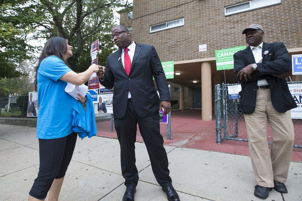 Boston mayoral candidate Tito Jackson fist bumps with a campaigner outside of the Holgate Apartments in Dorchester shortly after voting. (Jesse Costa/WBUR)