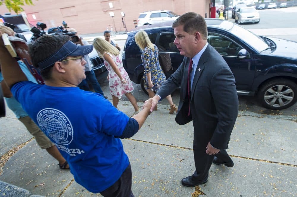 Boston Mayor Marty Walsh greets supporters outside of the Lower Mills Library in Dorchester on his way in to vote. (Jesse Costa/WBIUR)