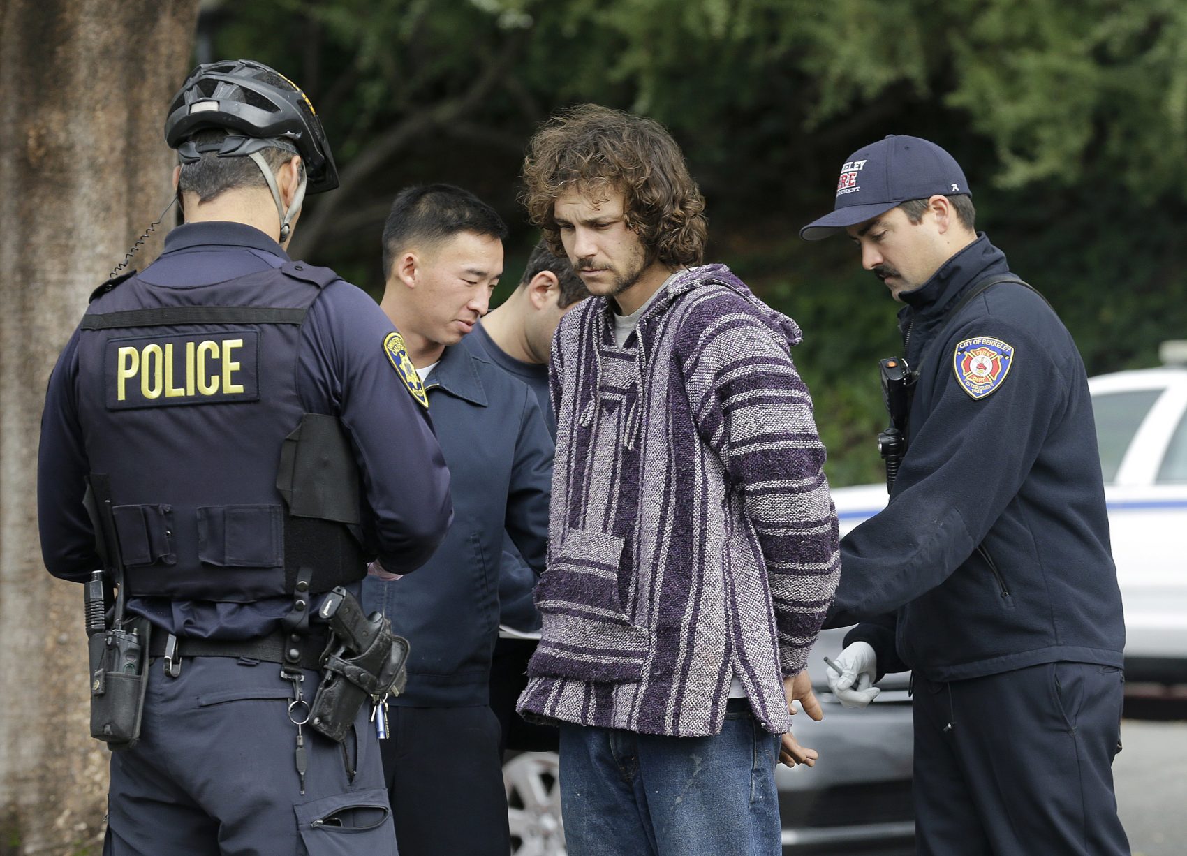 Police officers arrest a man who attacked a student on the University of California, Berkeley campus in Berkeley, Calif., Thursday, Feb. 2, 2017. Jack Palkovic, a student wearing a "Make America Great Again" hat, was attacked on the University of California, Berkeley campus a day after violent protests led authorities to cancel a controversial speech. (Jeff Chiu/AP)